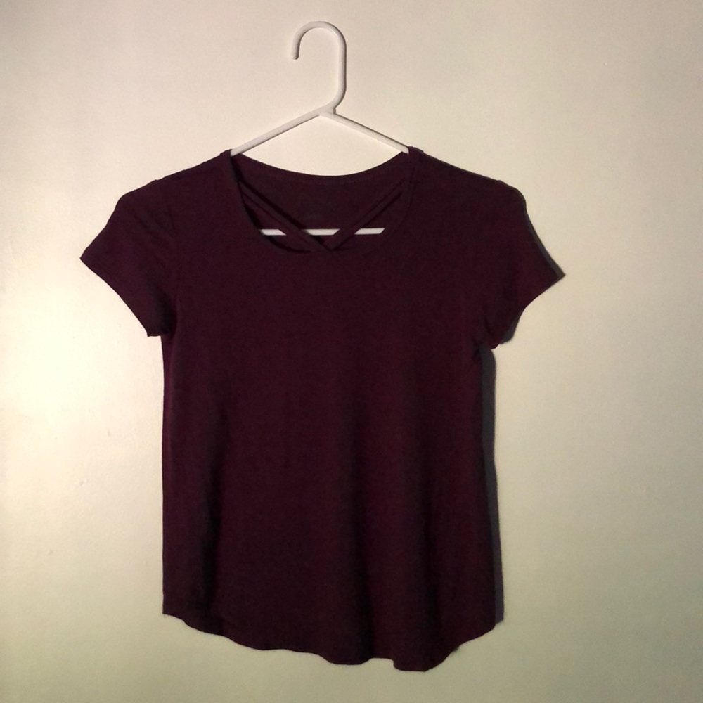 a maroon tee with a criss cross like detail